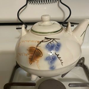 A beautiful vintage tea pot pink & blue flowers with brass handle